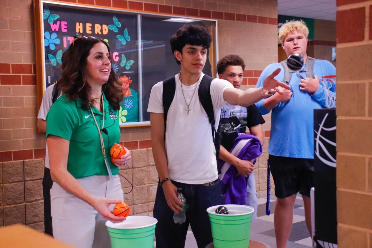 Student competes against staff in basketball for sweet prizes.